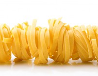 row dry nest pasta on white with reflection